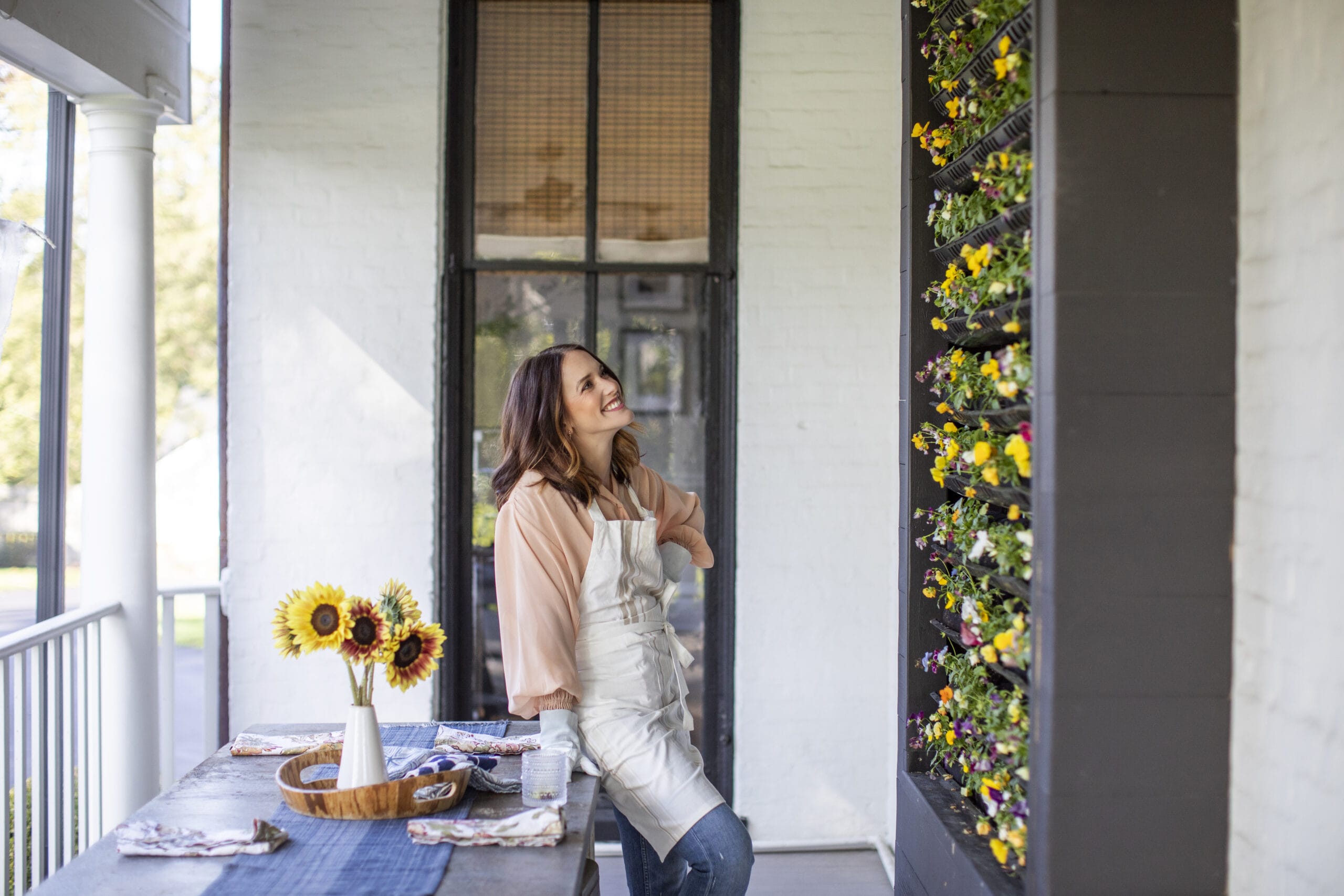 Vertical gardening with woman on front porch